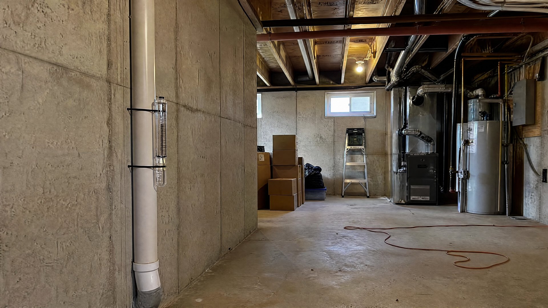 Radon mitigation system pipe and fan installed on a Sioux Falls SD home